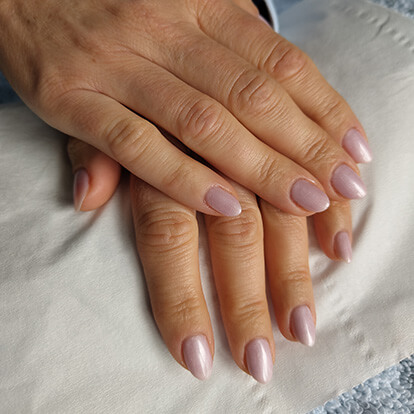 Photo of a pair of manicured hands with painted nails