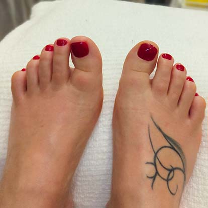 Photo of pedicured feet with painted toes